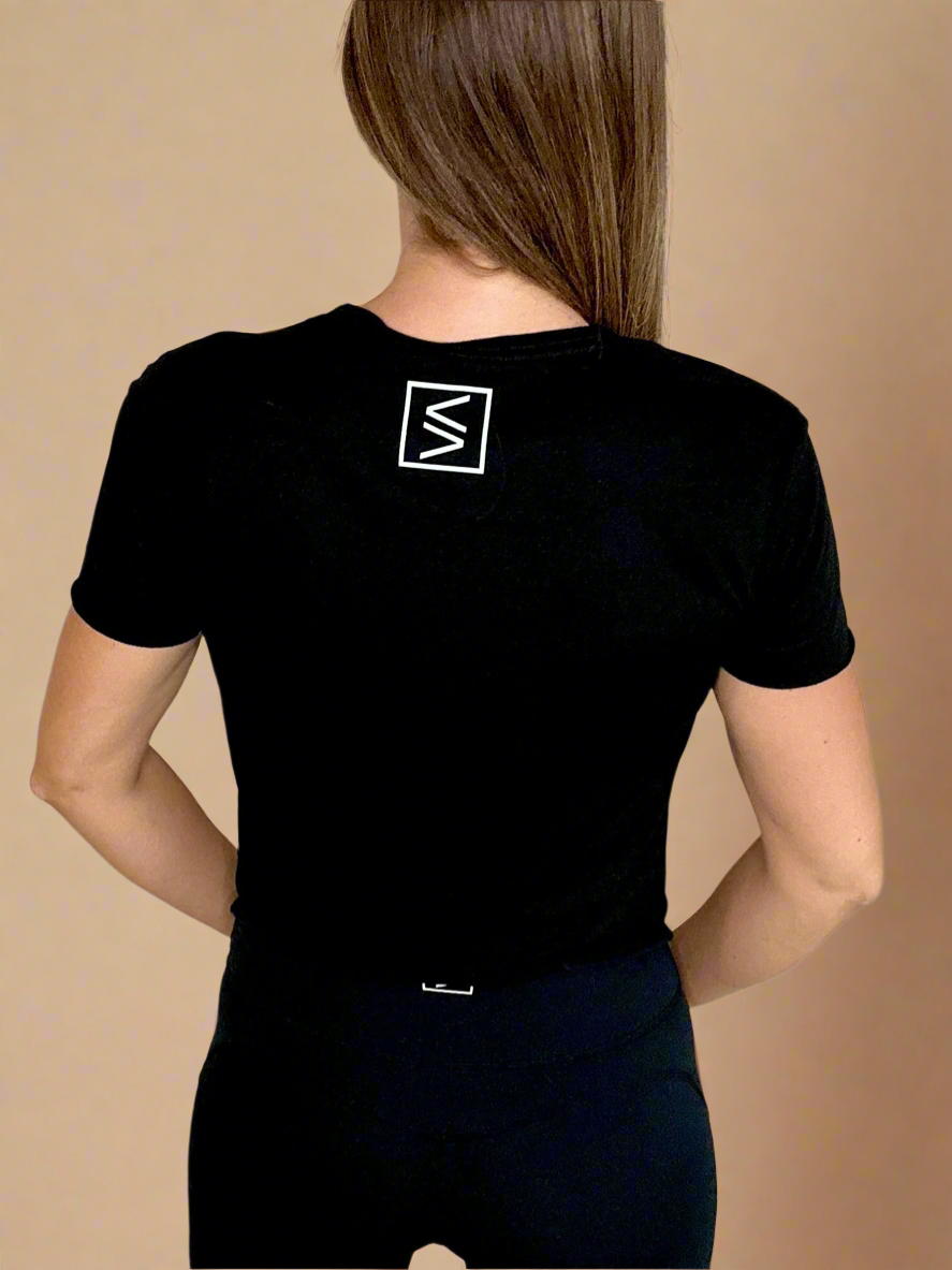 Female model wearing the Bleeding Excellence Crop T showcasing the back of the shirt.