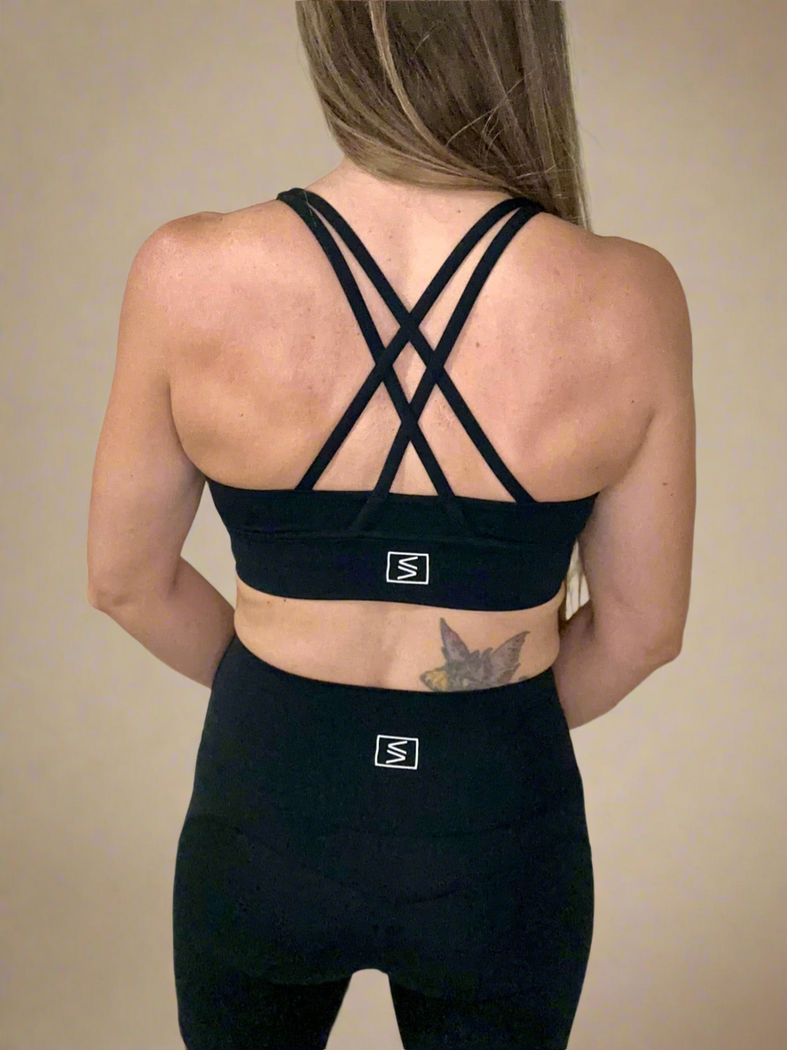 Back of female model wearing Powerflow Axis Bra in Black.