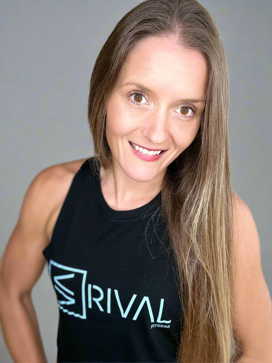 Female model showcasing Legend Classic Crop Tank in Ocean Black.