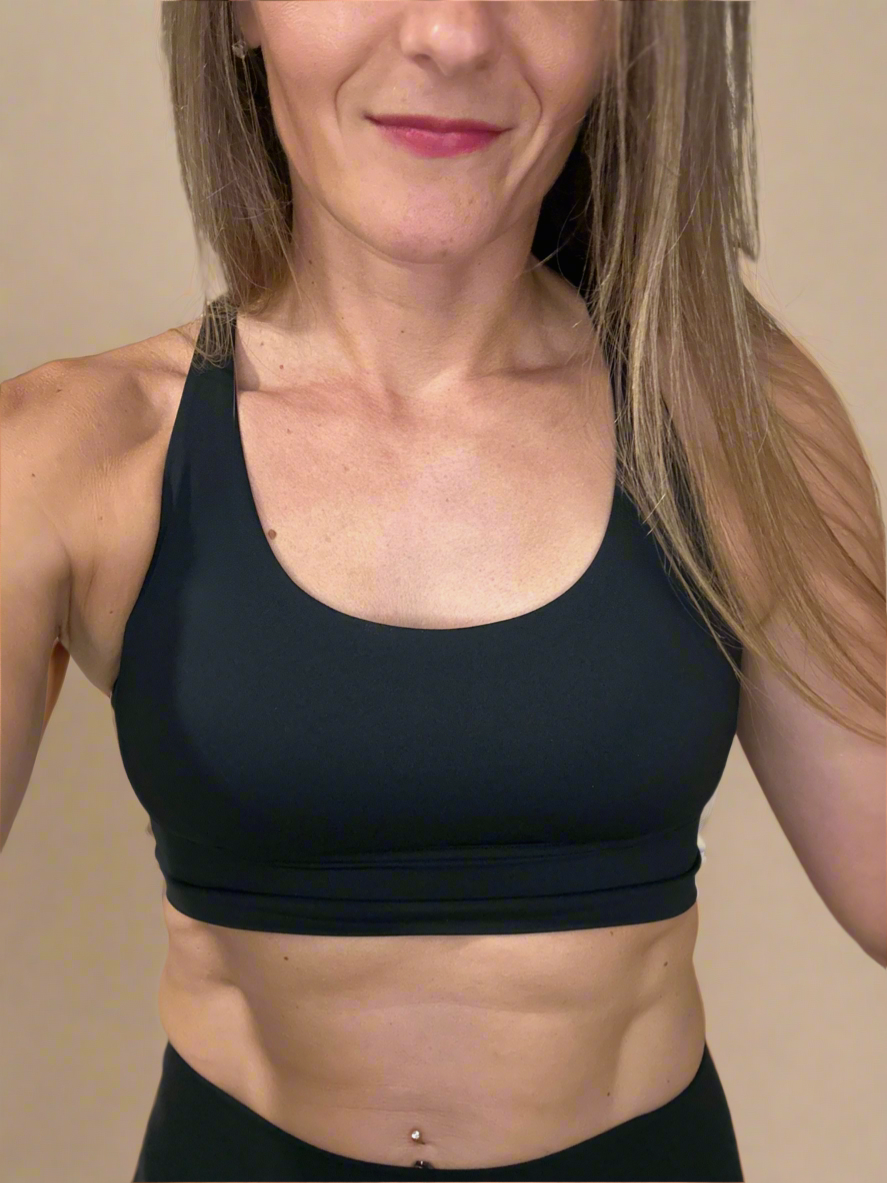 Female model wearing front of Powerflow Axis Bra in Black.