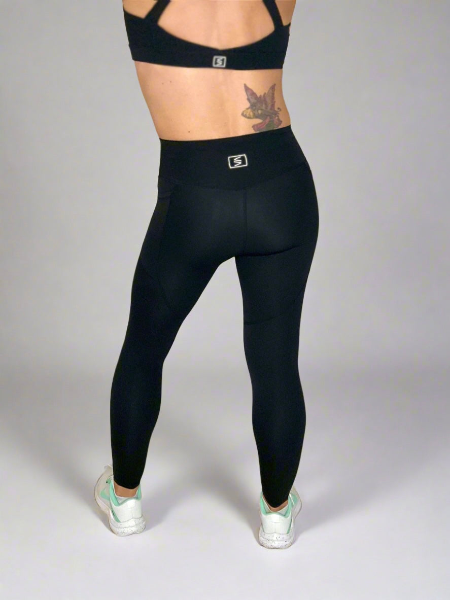 Back of model showcasing Rival Fit Gear Ignite Pocket Leggings in Black.