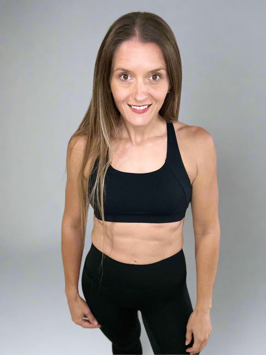 Model wearing Ignite X Bra in color black by Rival Fit Gear.