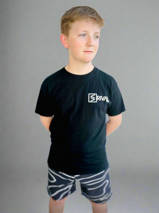 Male model wearing Legend Classic T Youth in black with Tidal Wave Shorts.