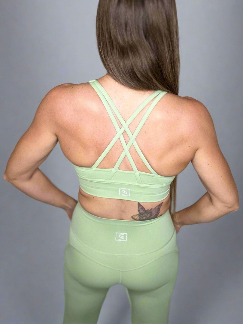 Female model wearing Powerflow Axis bra in Mint.