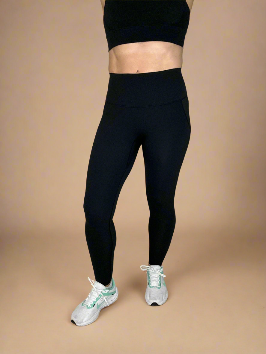 Model wearing Powerflow Leggings in Black from Front View.