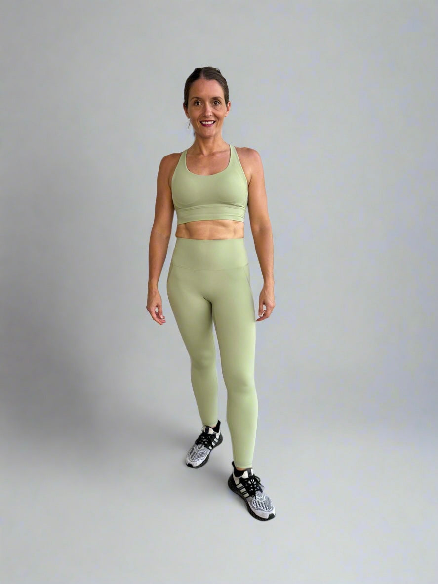 Female model wearing Powerflow workout set in Mint front side view.