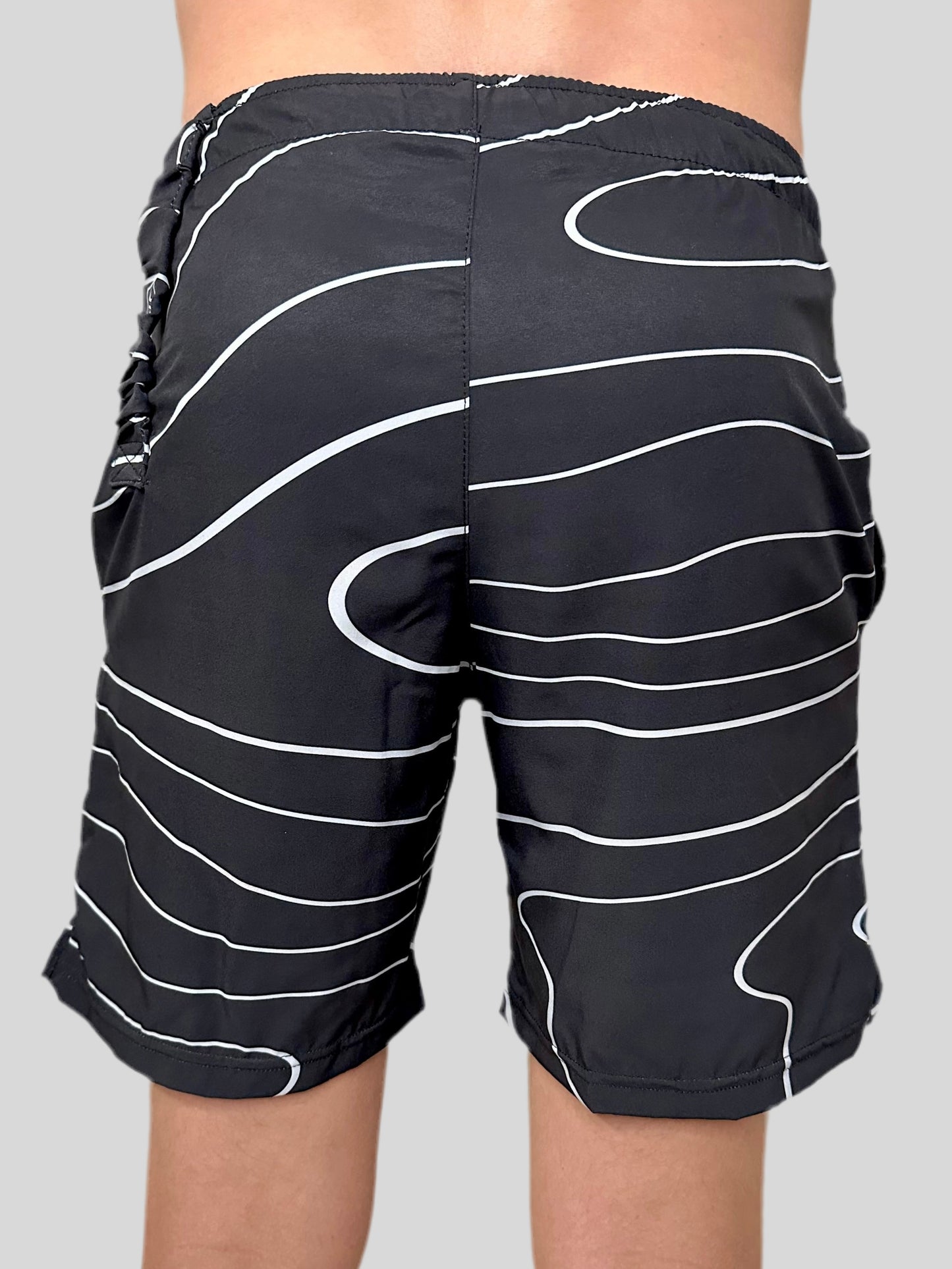 Model wearing Tidal Wave Men's shorts by Rival Fit Gear.