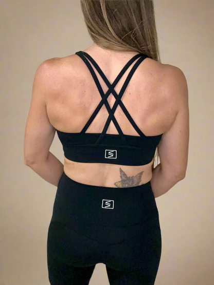 Back of female model wearing Powerflow Axis Bra in Black.