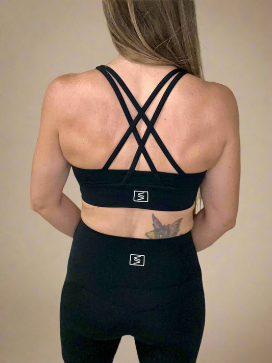 Back of female model wearing Powerflow Axis Bra in Black.