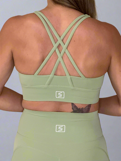 Model showcasing back of Powerflow Axis Bra in Mint.