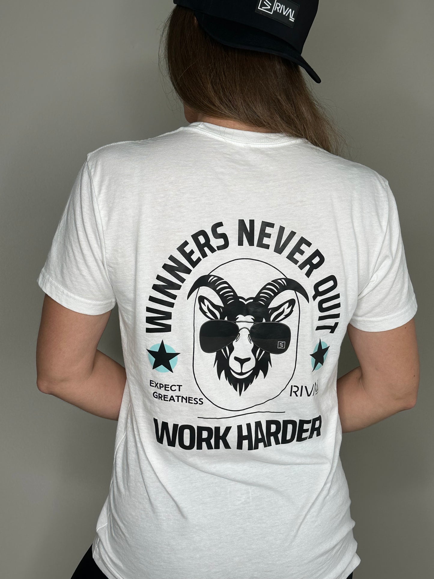 Person wearing a white t-shirt with motivational text and logo on the back.