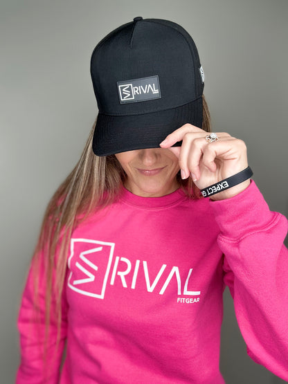 Female model tipping Rival Fit Gear hat and wearing bracelet and sweatshirt.