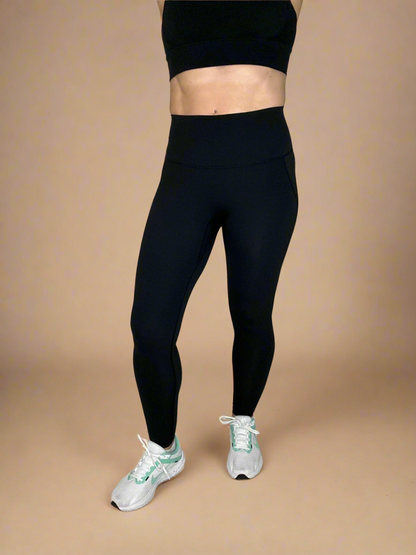 Model wearing Powerflow Leggings in Black from Front View.