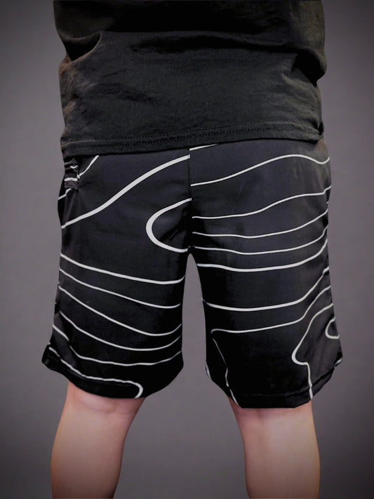 Boy wearing Rival Fit Gear Tidal Wave shorts. 